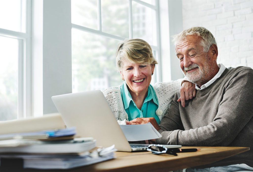 couple on laptop together researching retirement planning